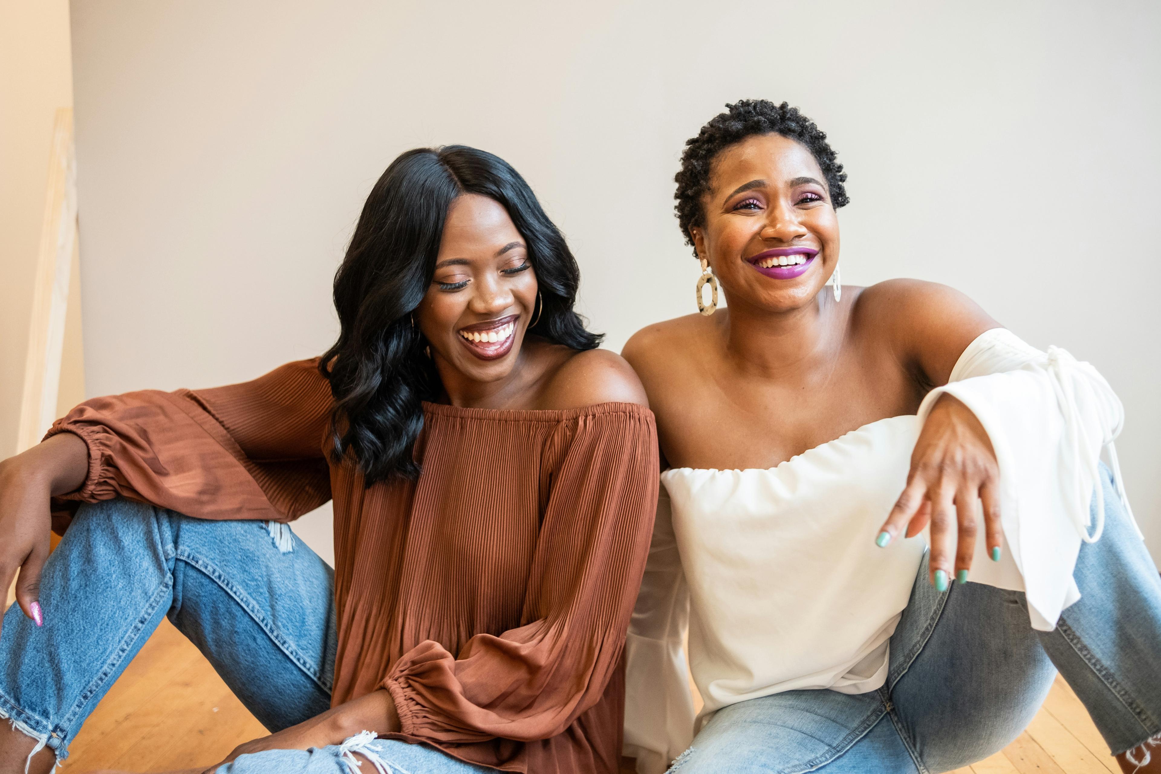 Two women laughing together in community